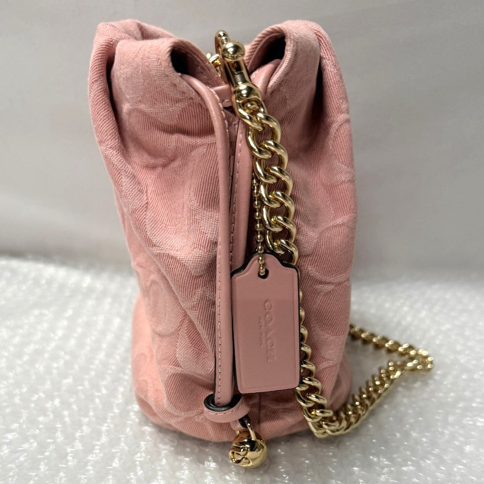 Pink quilted handbag with gold chain and tag on a white surface with 'Fancy Tokyo Tokyo' packaging.