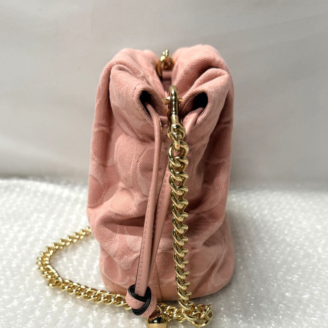 Pink velvet drawstring bag with gold chain on a white surface, featuring an 'Fancy Tokyo Tokyo' tag.