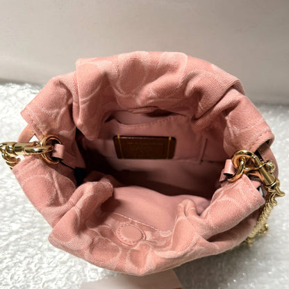 Pink velvet handbag with gold chain handle on a white background, featuring a 'Fancy Tokyo' tag.