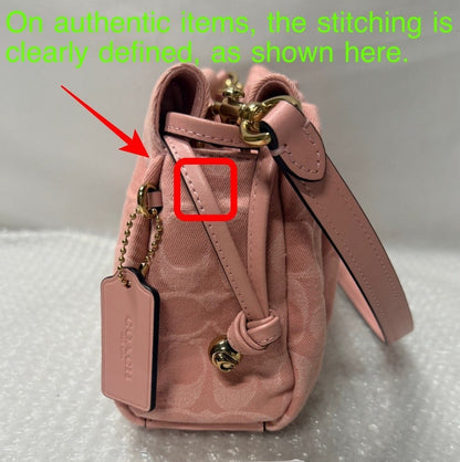Pink handbag with gold accents on a gray surface, featuring an 'Fancy Tokyo Tokyo' book.